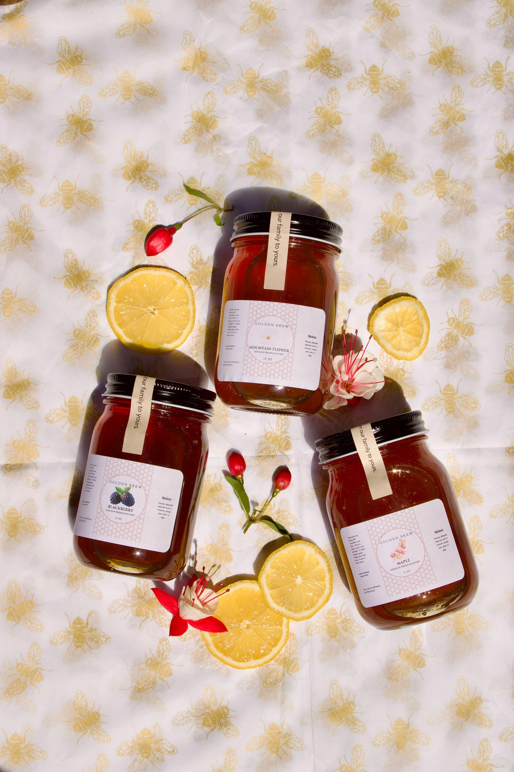 Top-down view of the three Golden Brew honey jars — Blackberry, Mountain Flower, and Bigleaf Maple