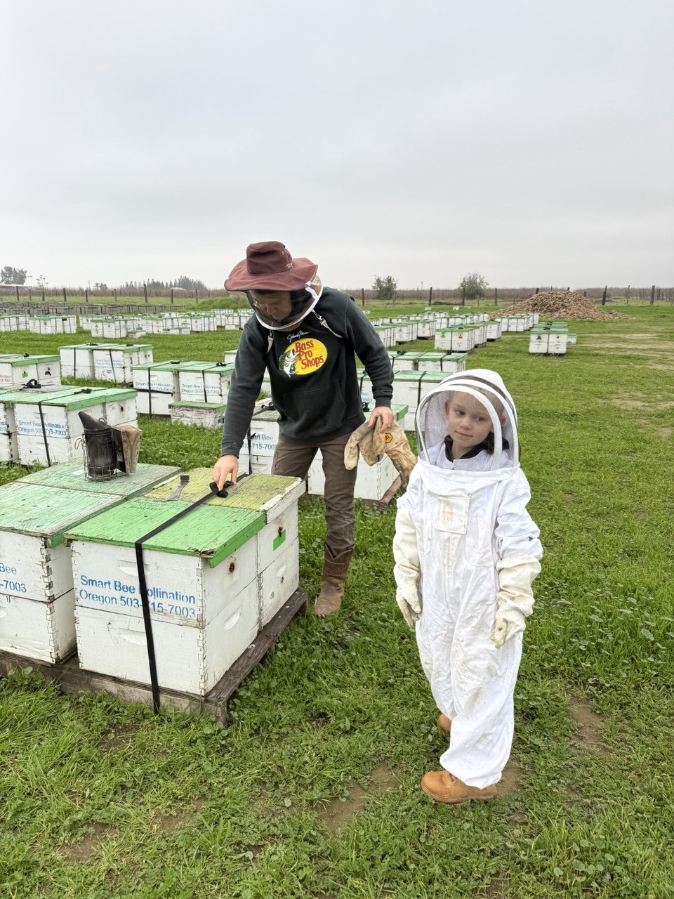 Valeriy and his son by the hives